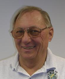 A man with glasses and a white shirt